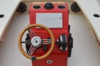 Slide: The Image of Red helm of 2023 ZCB Curlew 18 boat with wooden steering wheel and controls. - 8