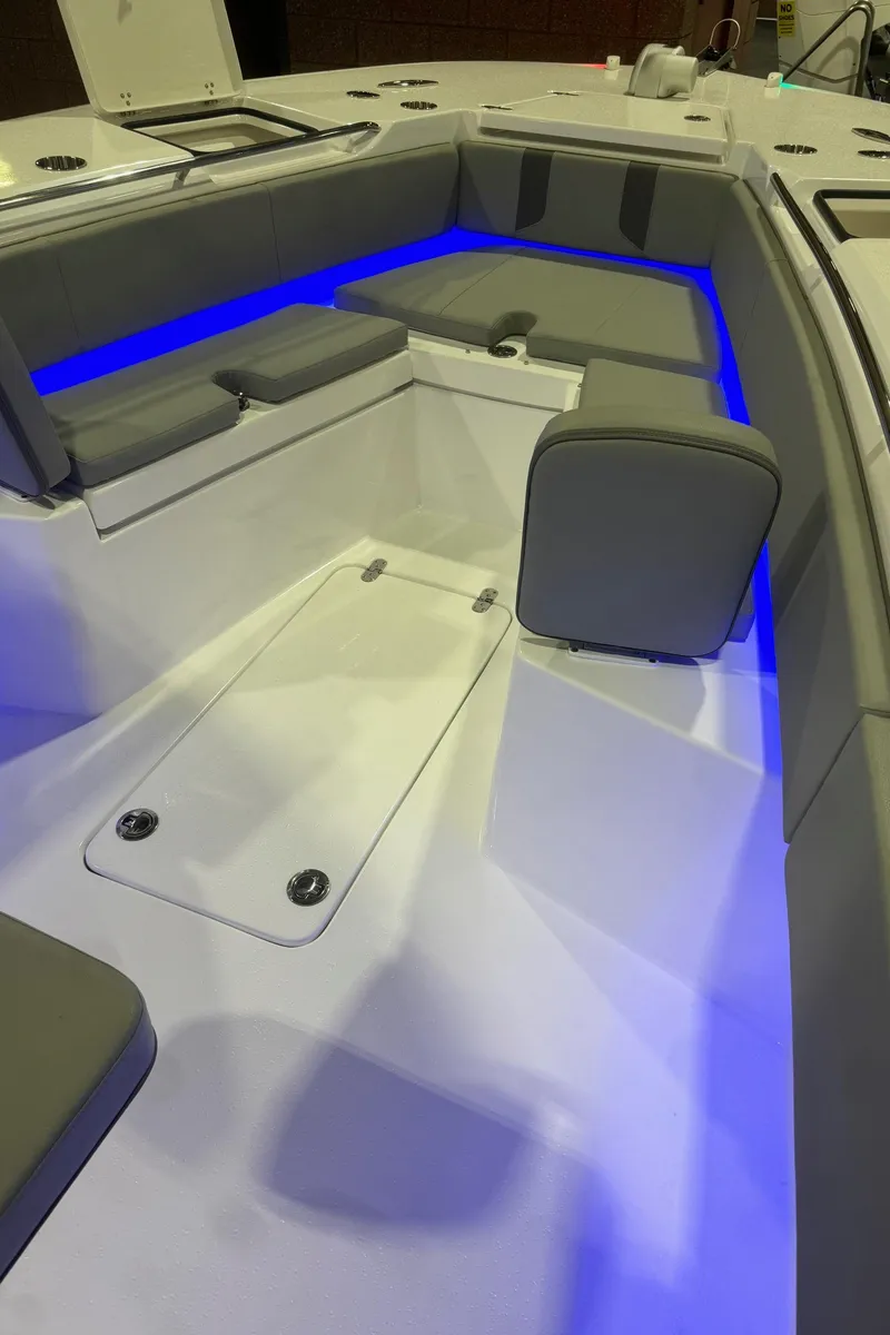 Slide: The Image of 2023 Cape Horn 34 XS boat interior with blue LED lighting and cushioned seating. - 11