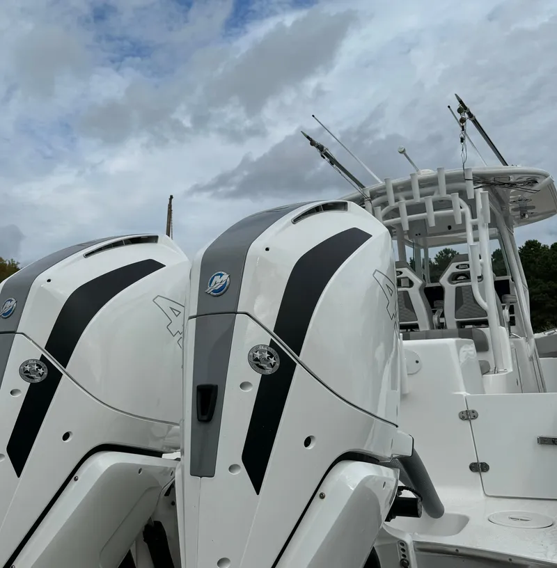 Slide: The Image of 2023 Cape Horn 34 XS boat with dual outboard engines under cloudy sky. - 18