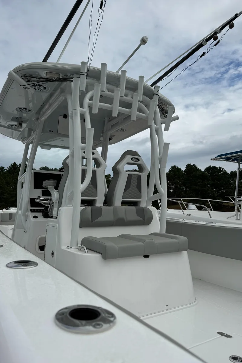 Slide: The Image of 2023 Cape Horn 34 XS boat with seating and rod holders, under cloudy sky. - 20
