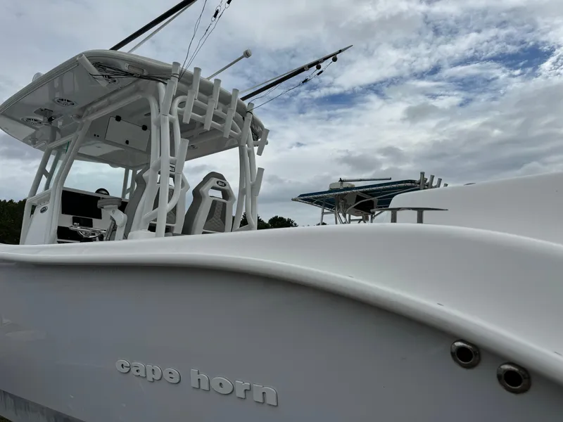 Slide: The Image of 2023 Cape Horn 34 XS boat with fishing rods against a cloudy sky. - 23