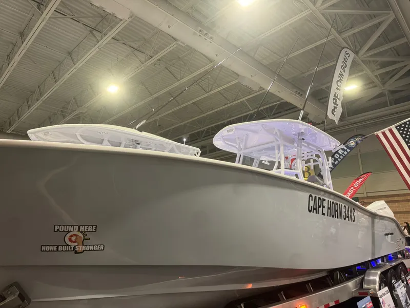 Slide: The Image of 2023 Cape Horn 34 XS boat displayed indoors with American flag in background. - 15