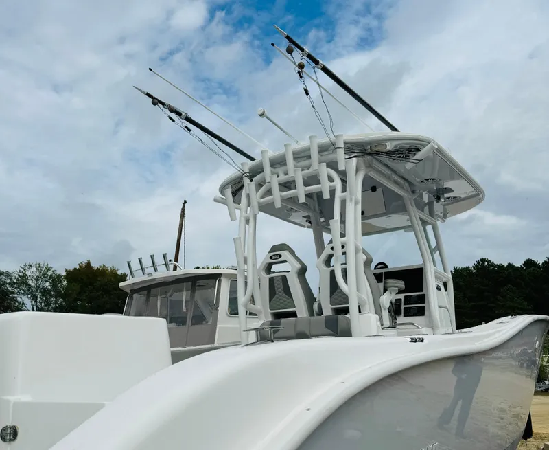 Slide: The Image of 2023 Cape Horn 34 XS boat with fishing rods, sleek design, and spacious deck. - 17