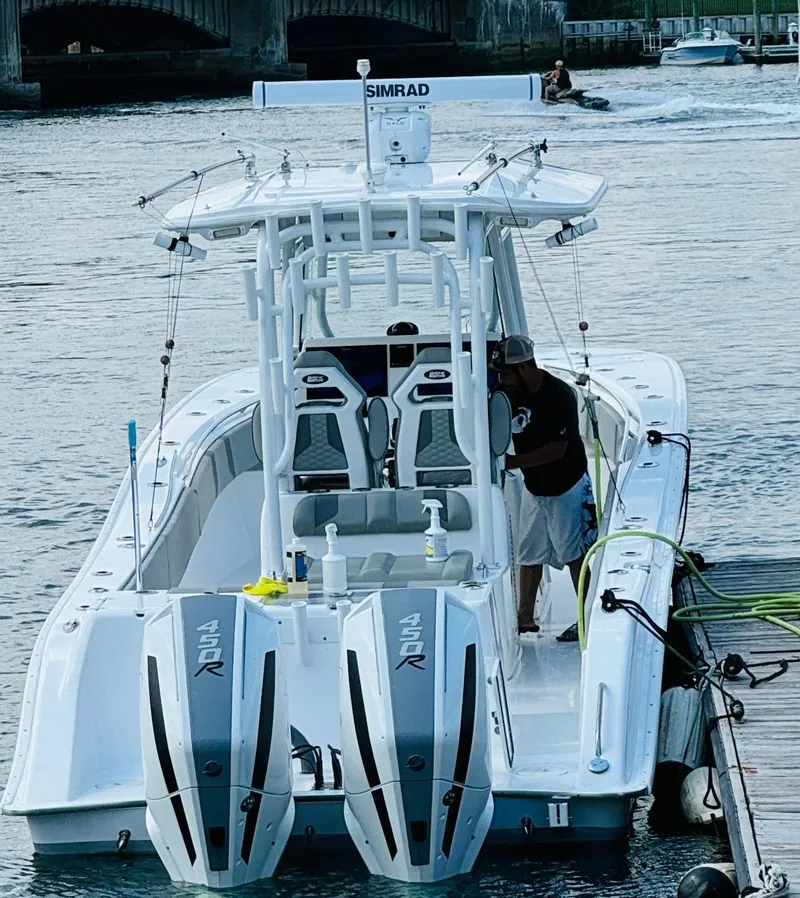 The Image of 2023 Cape Horn 34 XS boat with twin 450R engines docked on water. - 2