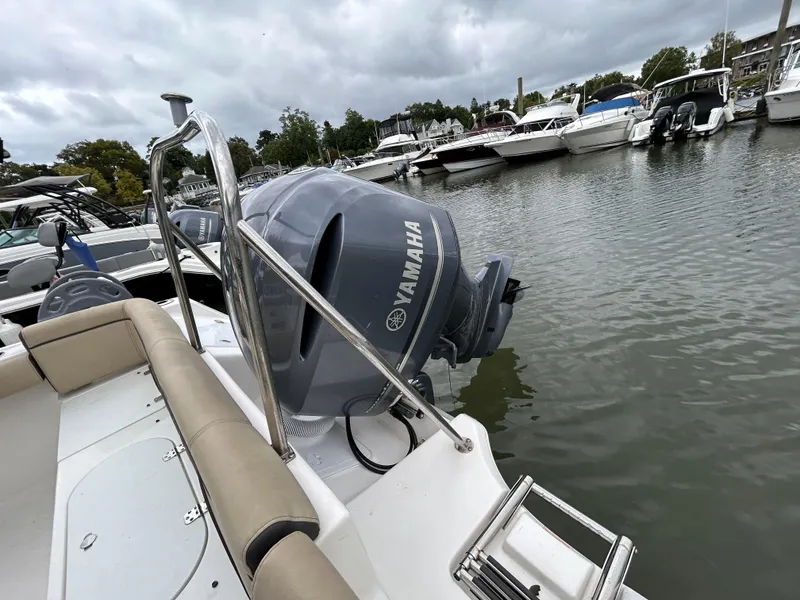Slide: The Image of 2021 Tidewater 232 LXF boat with Yamaha engine docked in marina. - 11