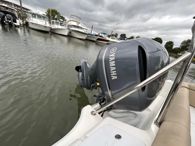 Slide: The Image of 2021 Tidewater 232 LXF boat with Yamaha outboard motor docked in marina. - 12