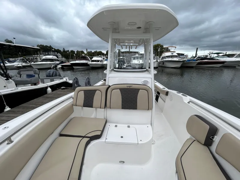 Slide: The Image of 2021 Tidewater 232 LXF boat with beige seating at a marina. - 4