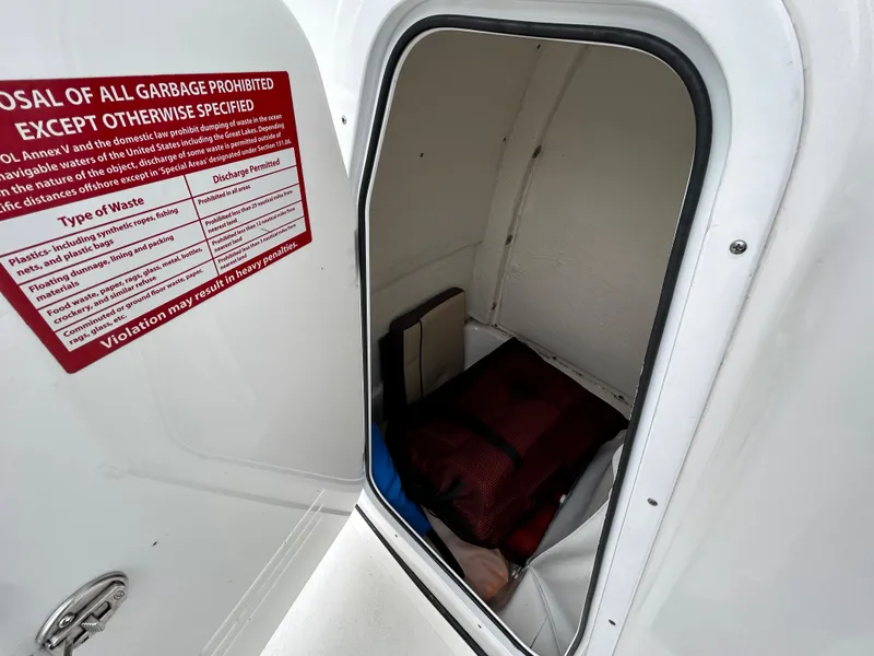 Slide: The Image of Storage compartment in 2021 Tidewater 232 LXF boat with safety equipment. - 5