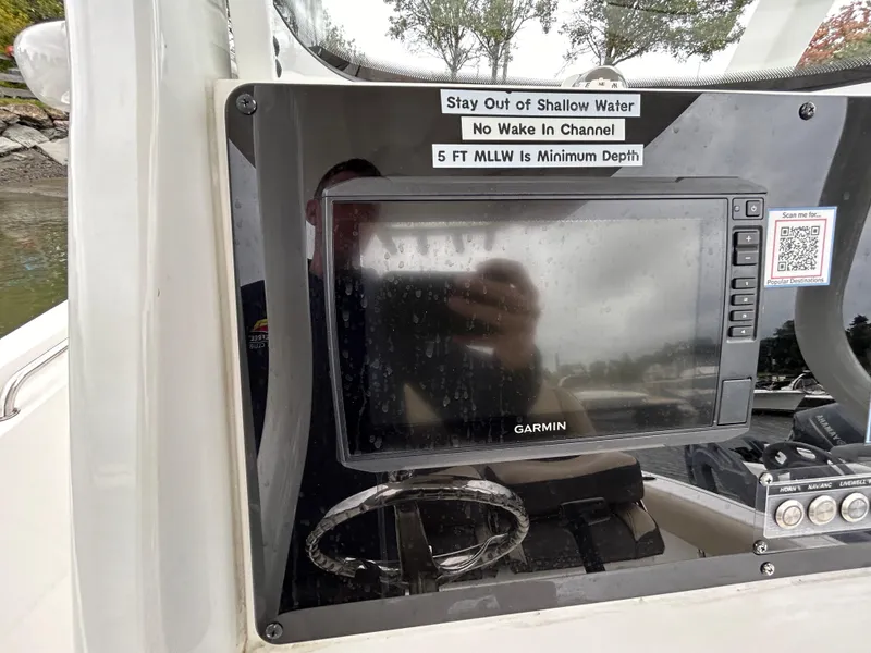 Slide: The Image of Garmin navigation system on 2021 Tidewater 232 LXF boat dashboard with safety instructions. - 6