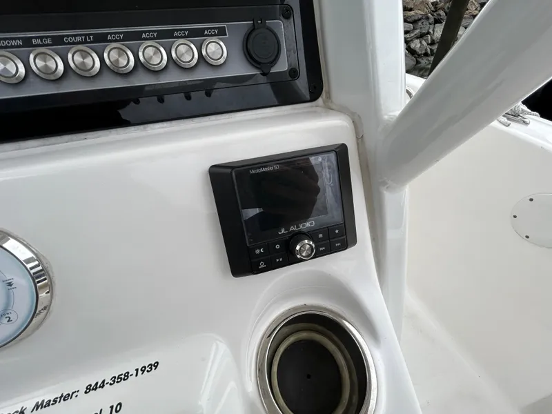 Slide: The Image of 2021 Tidewater 232 LXF boat dashboard with JL Audio system and control panel. - 7