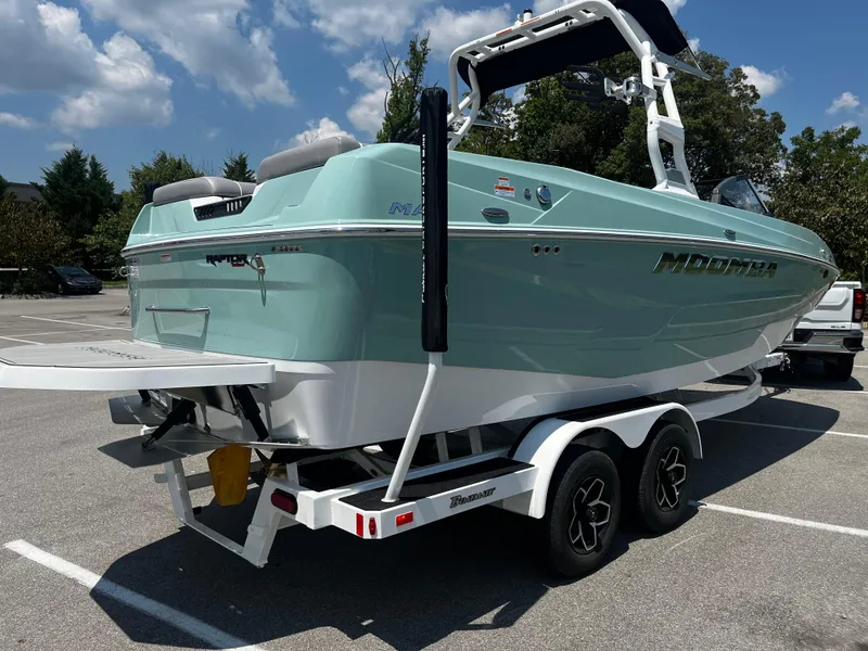 Slide: The Image of 2025 Moomba Max boat on trailer in parking lot, sunny day. - 4