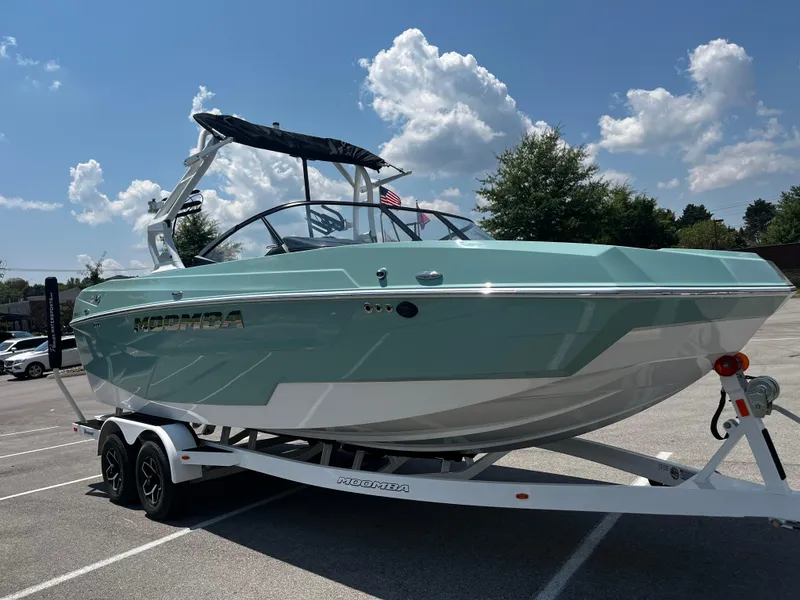 Slide: The Image of 2025 Moomba Max boat on trailer under blue sky. - 6
