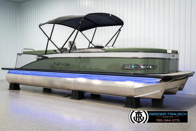 Slide: The Image of 2025 Avalon Catalina Entertainer pontoon boat with canopy and blue underglow lighting. - 2