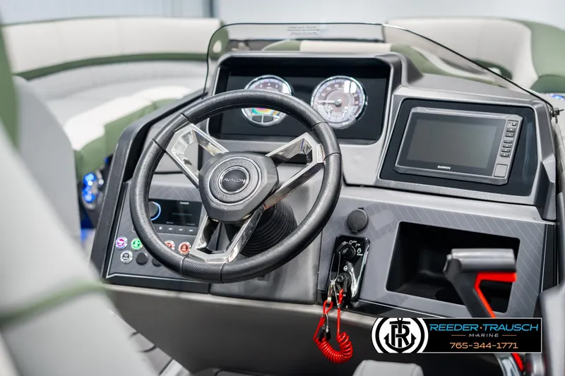 Slide: The Image of 2025 Avalon Catalina Entertainer boat dashboard with steering wheel and control panel. - 28
