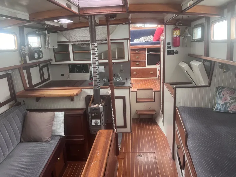 Slide: The Image of Interior of 1986 Covey Island 38 sailboat with wooden finishes and cozy seating. - 14