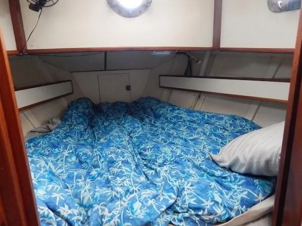 Slide: The Image of Cozy cabin interior of 1986 Covey Island 38 sailboat with blue bedding. - 17