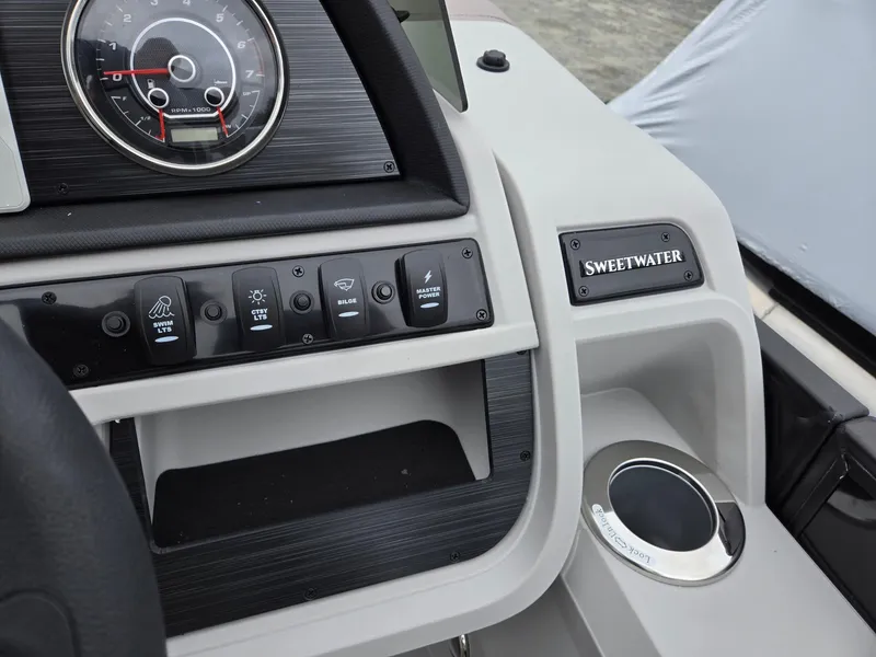 Slide: The Image of Dashboard of 2025 Godfrey SWEETWATER 2286 SFL boat with control panel and cup holder. - 17