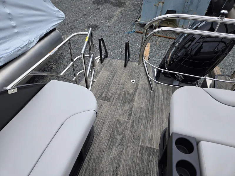Slide: The Image of 2025 Godfrey SWEETWATER 2286 SFL boat interior with gray seating and wood-style flooring. - 23