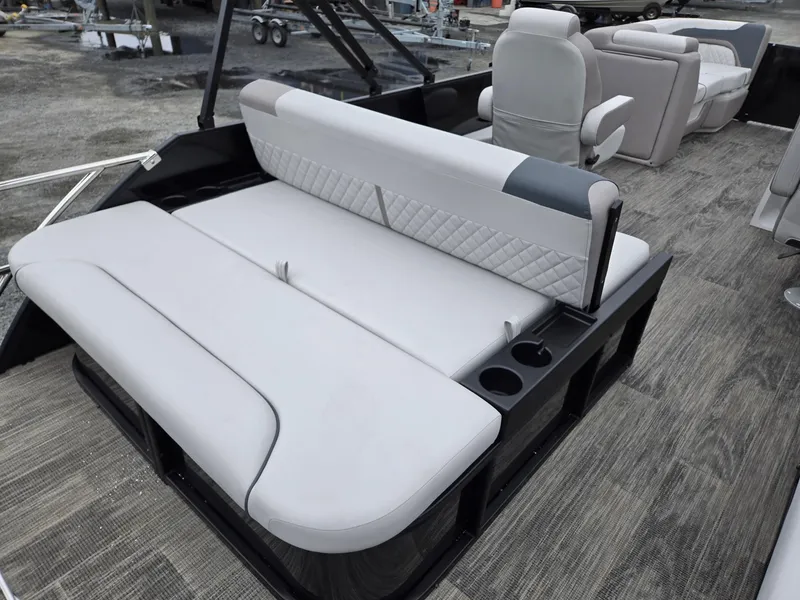 Slide: The Image of 2025 Godfrey SWEETWATER 2286 SFL boat interior with plush seating and cup holders. - 25