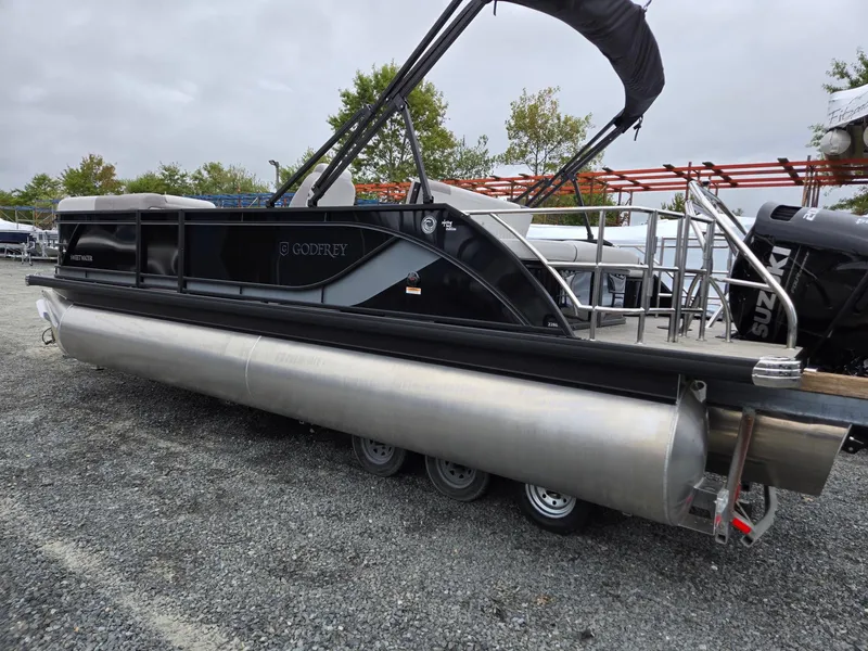 Slide: The Image of 2025 Godfrey SWEETWATER 2286 SFL pontoon boat on gravel lot. - 3