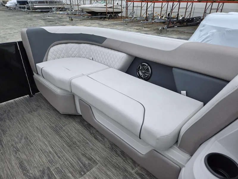 Slide: The Image of 2025 Godfrey SWEETWATER 2286 SFL boat interior with cushioned seating and speaker. - 34