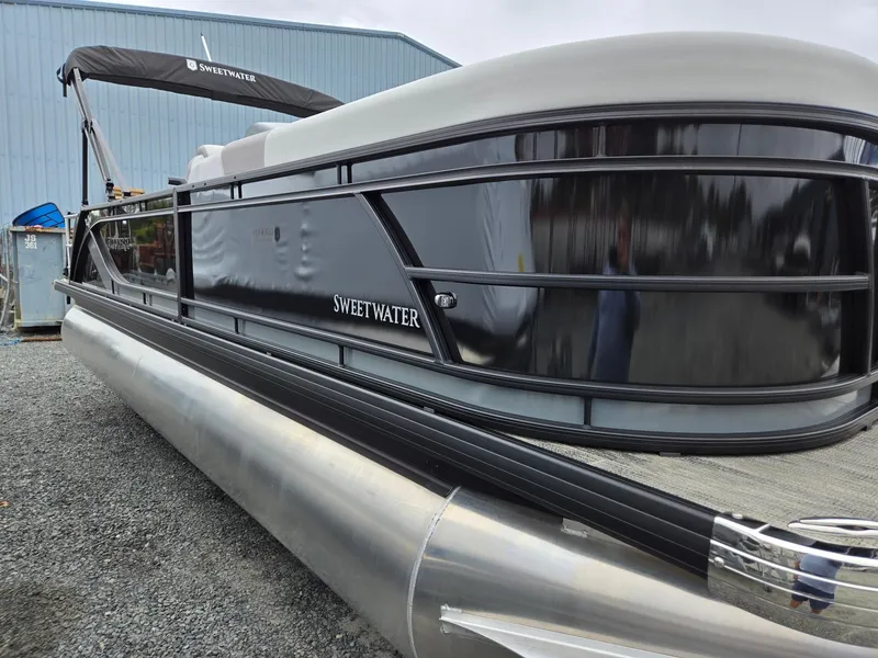 Slide: The Image of 2025 Godfrey SWEETWATER 2286 SFL pontoon boat with sleek black exterior. - 6