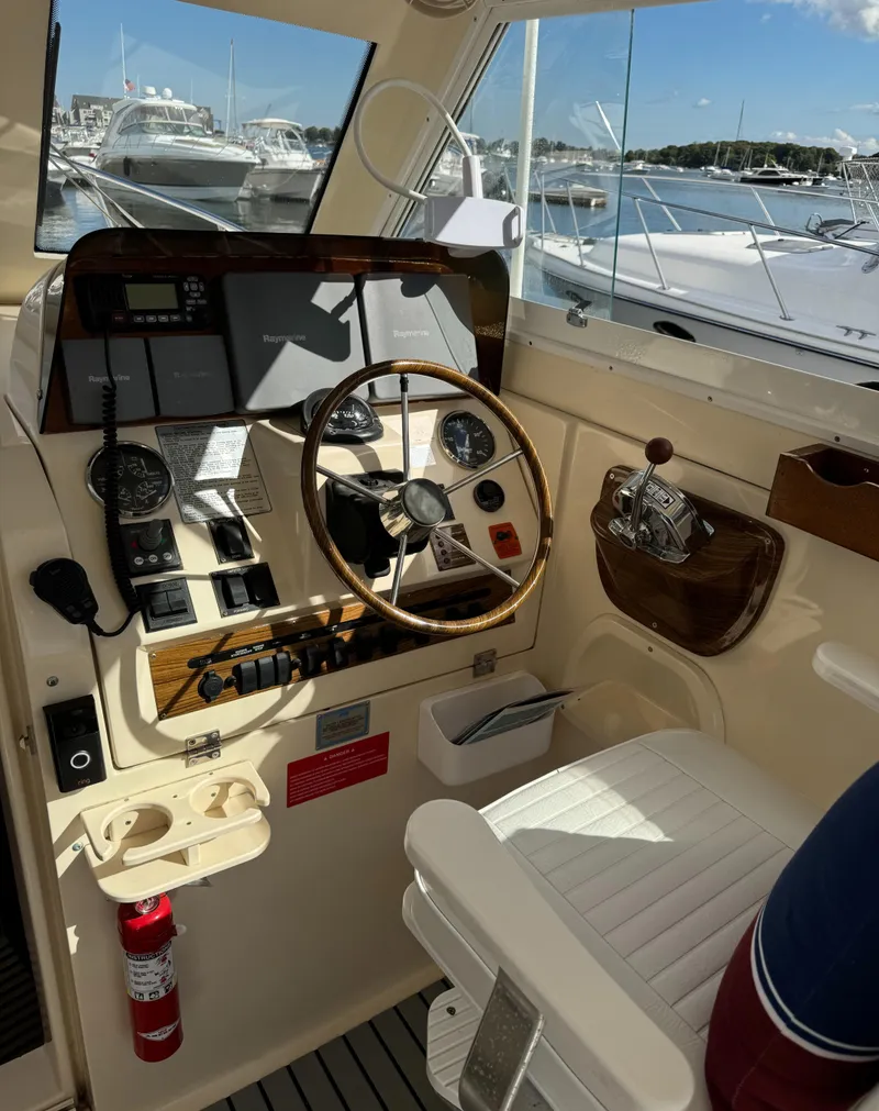 Slide: The Image of 2004 Mainship 30 Pilot II Express Cruiser helm with steering wheel and control panel. - 14