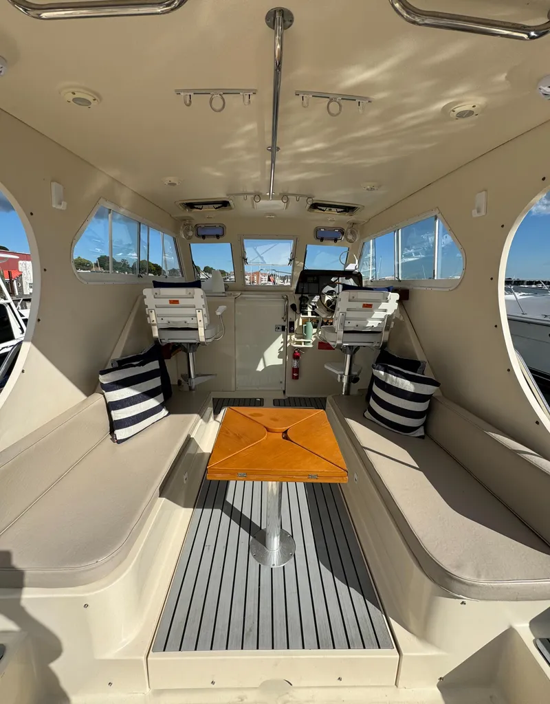 Slide: The Image of 2004 Mainship 30 Pilot II Express Cruiser interior with seating and table. - 16
