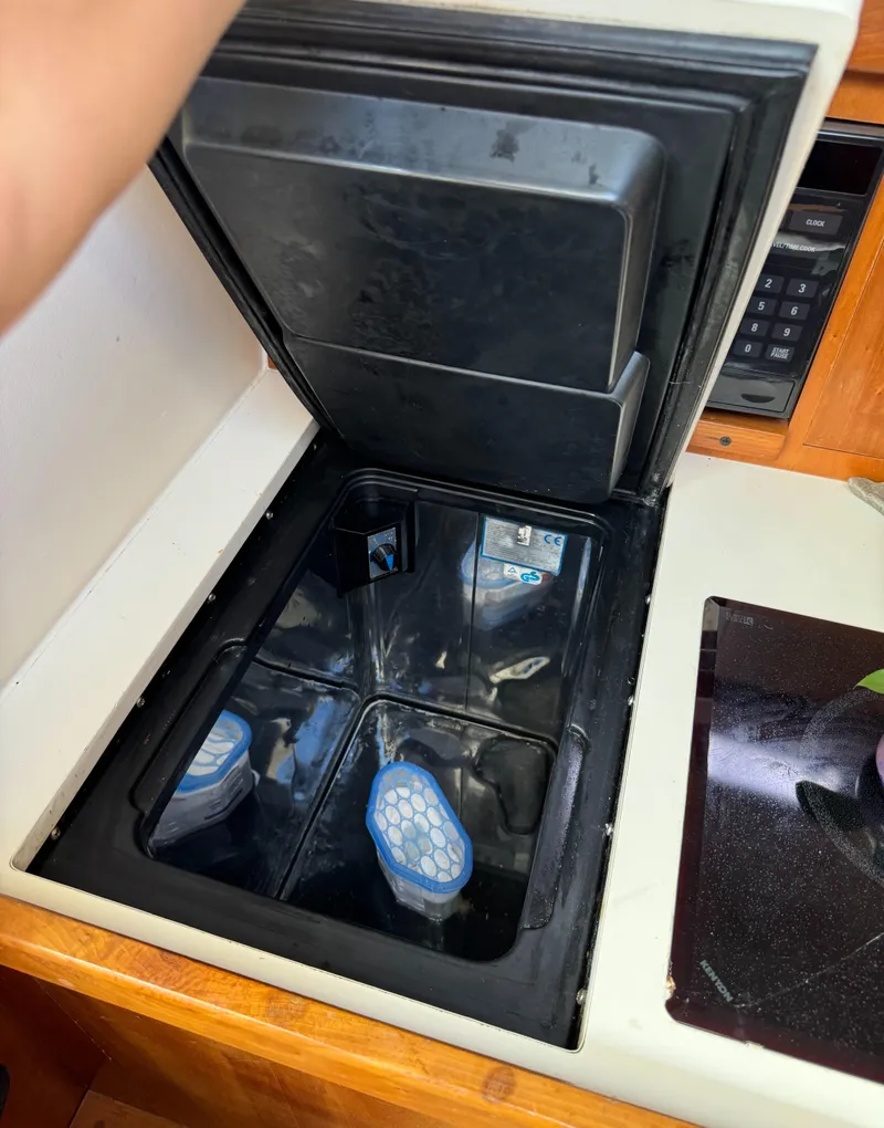 Slide: The Image of Open storage compartment in 2004 Mainship 30 Pilot II Express Cruiser interior. - 21