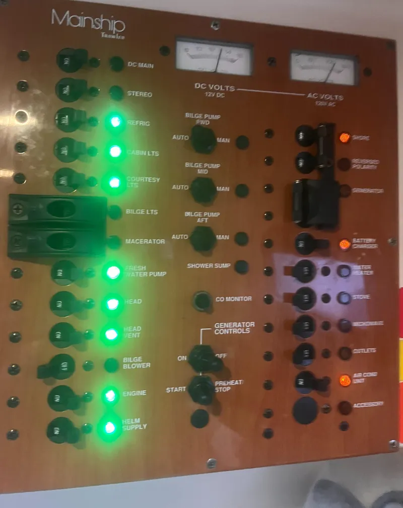 Slide: The Image of Control panel of 2004 Mainship 30 Pilot II Express Cruiser with illuminated switches and gauges. - 25