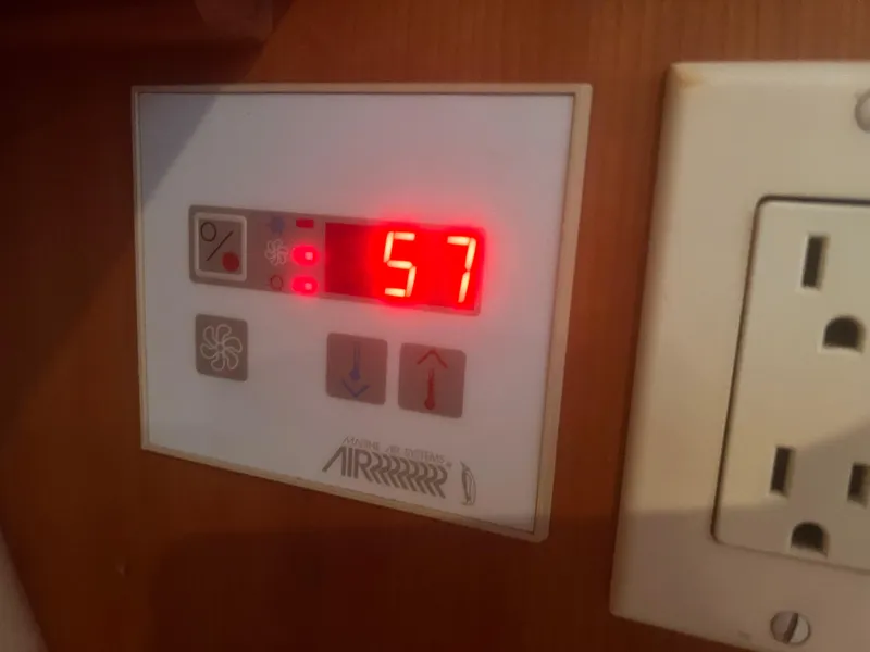 Slide: The Image of Digital control panel displaying "57" on a 2004 Mainship 30 Pilot II Express Cruiser. - 29