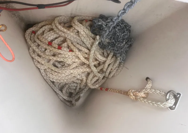 Slide: The Image of Coiled rope in a 2004 Mainship 30 Pilot II Express Cruiser's storage compartment. - 32