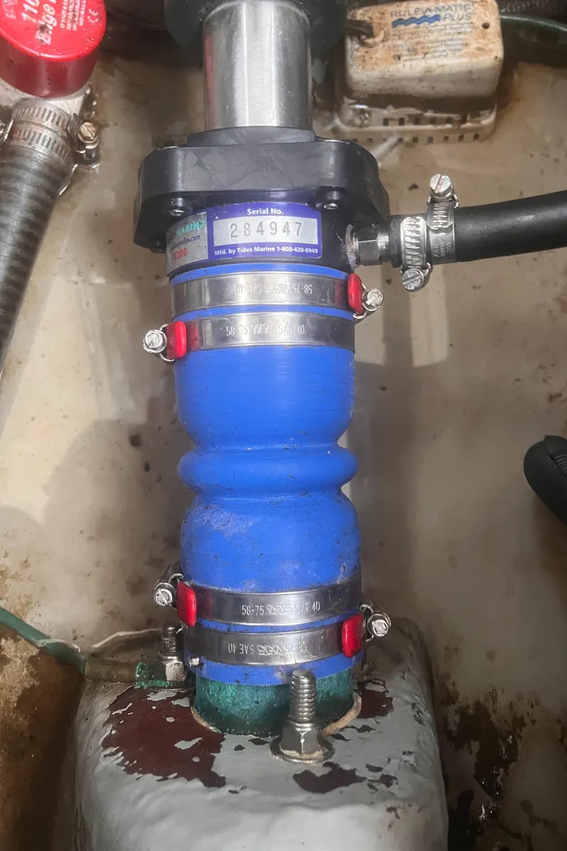 Slide: The Image of Close-up of a 2004 Mainship 30 Pilot II Express Cruiser engine component with blue hose and clamps. - 33