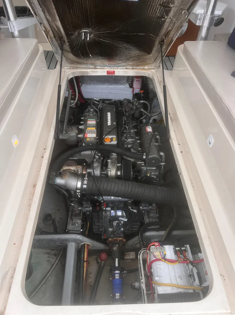 Slide: The Image of Engine compartment of 2004 Mainship 30 Pilot II Express Cruiser, showcasing mechanical components. - 34