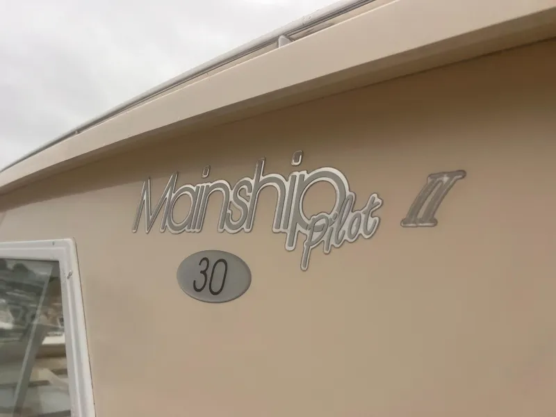 Slide: The Image of 2004 Mainship 30 Pilot II Express Cruiser logo on boat exterior. - 35