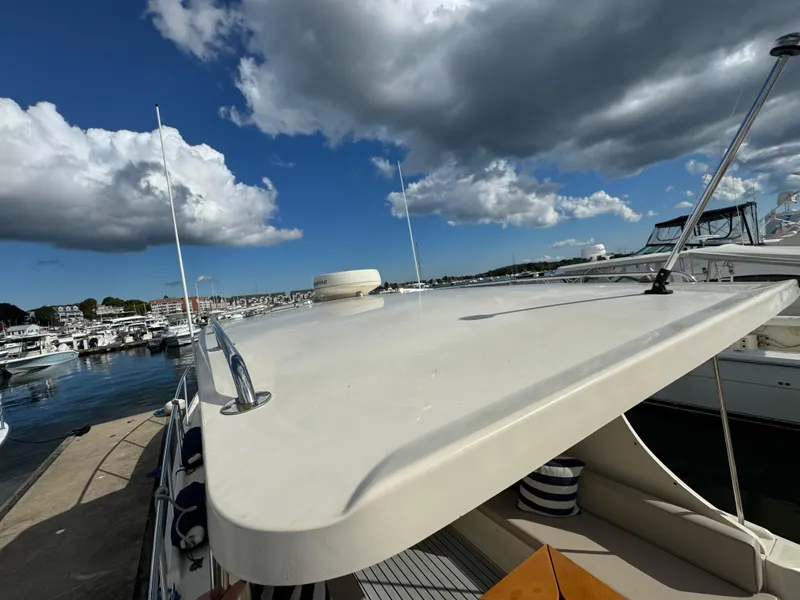 Slide: The Image of 2004 Mainship 30 Pilot II Express Cruiser docked under a partly cloudy sky. - 8