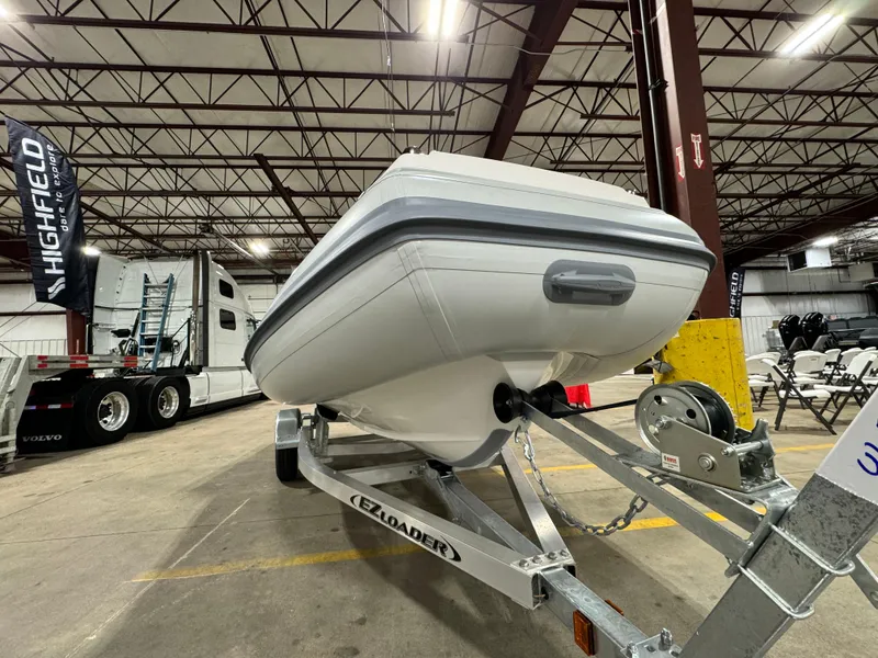 Slide: The Image of 2025 Highfield Velox 420 boat on trailer in warehouse setting. - 13