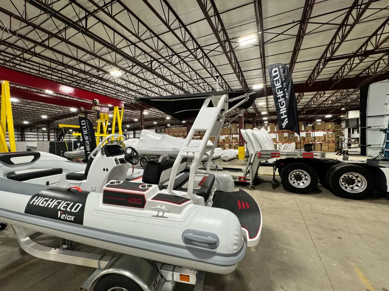 Slide: The Image of 2025 Highfield Velox 420 boat displayed in a warehouse setting. - 16