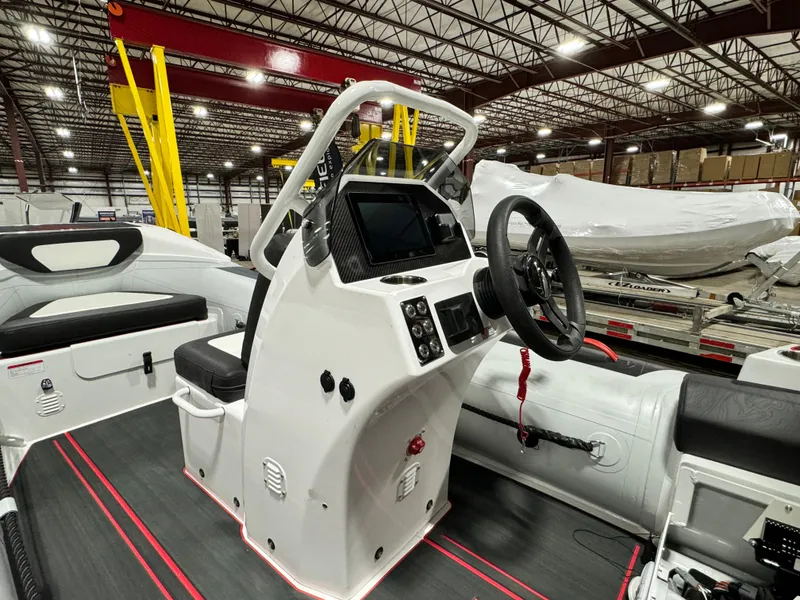Slide: The Image of 2025 Highfield Velox 420 boat interior with steering console in a warehouse setting. - 4