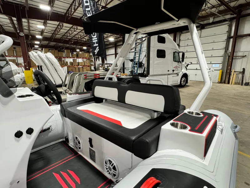 Slide: The Image of 2025 Highfield Velox 420 boat interior with seating and modern design in a warehouse setting. - 5