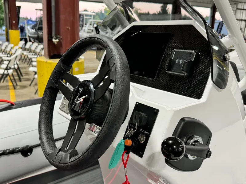 Slide: The Image of Steering console of 2025 Highfield Velox 420 boat, featuring modern controls and sleek design. - 6