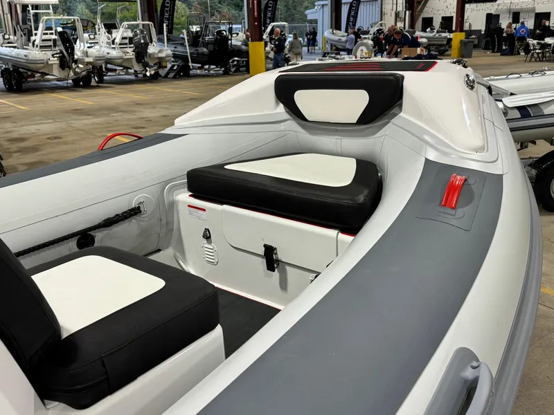 Slide: The Image of 2025 Highfield Velox 420 boat interior with black and white seating, showcased at a marine event. - 8