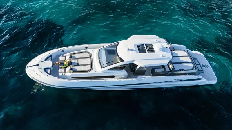 Slide: The Image of 2025 Canados 571 yacht cruising on clear blue water, aerial view. - 4