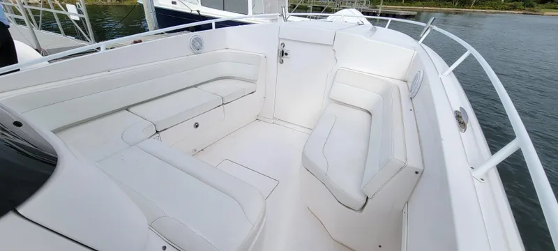 Slide: The Image of 2016 Intrepid 327 Cuddy boat interior with white seating and sleek design. - 10