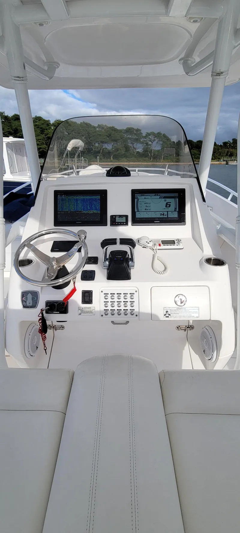 Slide: The Image of 2016 Intrepid 327 Cuddy boat cockpit with modern navigation equipment. - 11