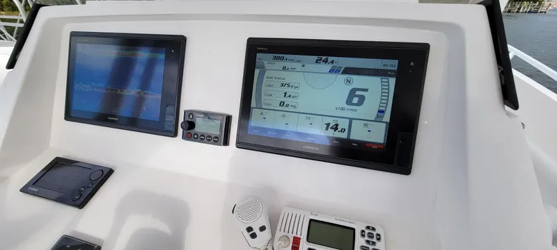 Slide: The Image of Dashboard of 2016 Intrepid 327 Cuddy with navigation and communication equipment. - 12