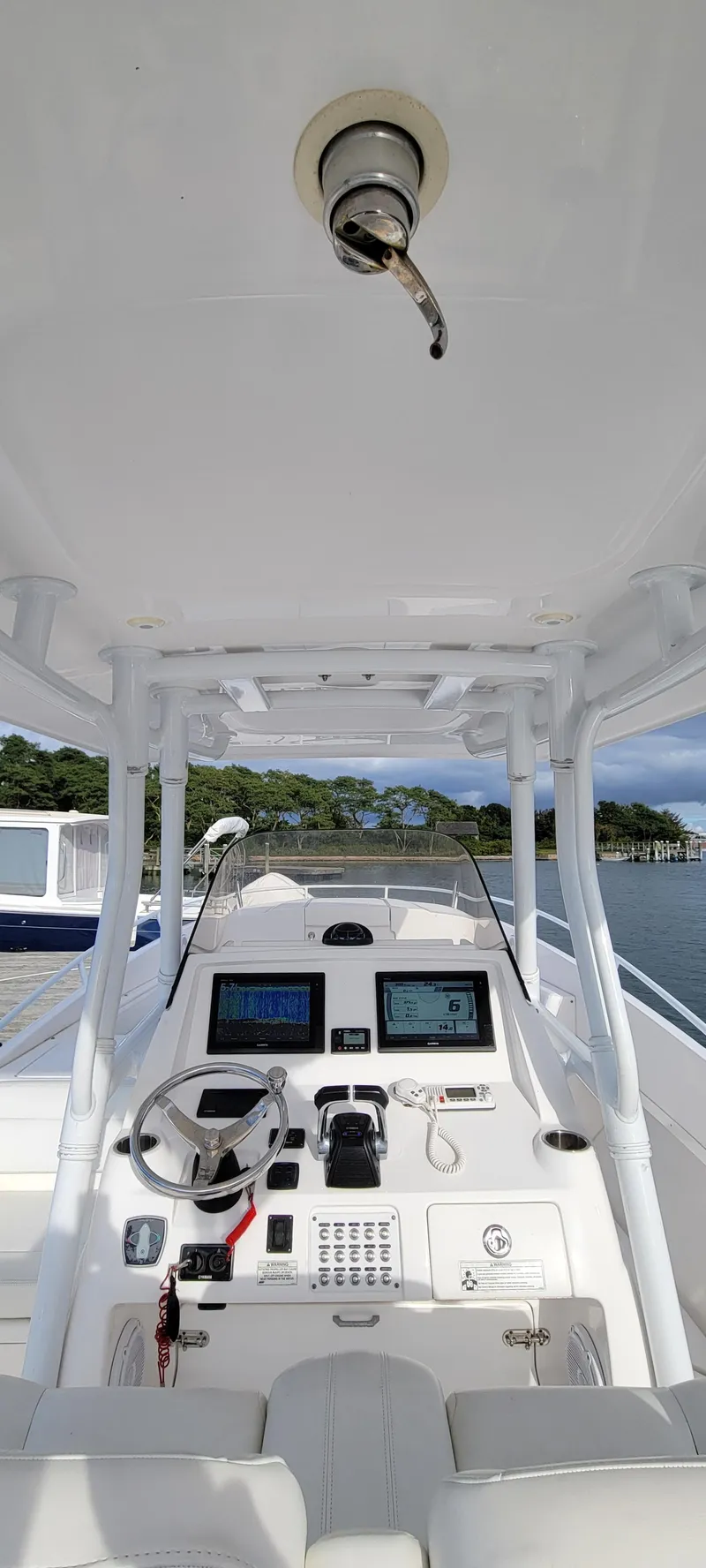 Slide: The Image of 2016 Intrepid 327 Cuddy boat cockpit with modern navigation equipment. - 13
