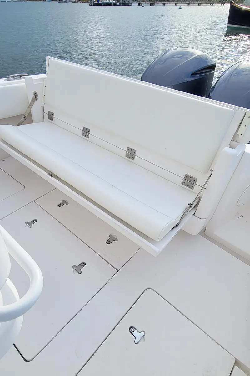 Slide: The Image of 2016 Intrepid 327 Cuddy boat with foldable seating and dual engines. - 18