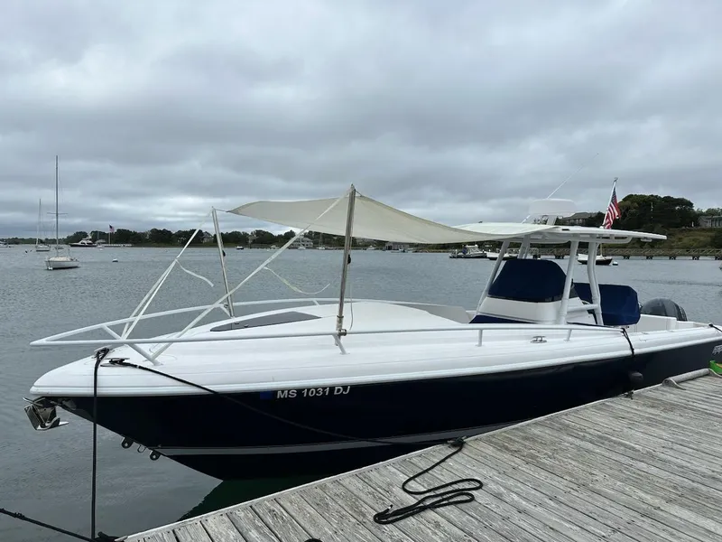Slide: The Image of 2016 Intrepid 327 Cuddy boat docked with canopy, overcast sky. - 25