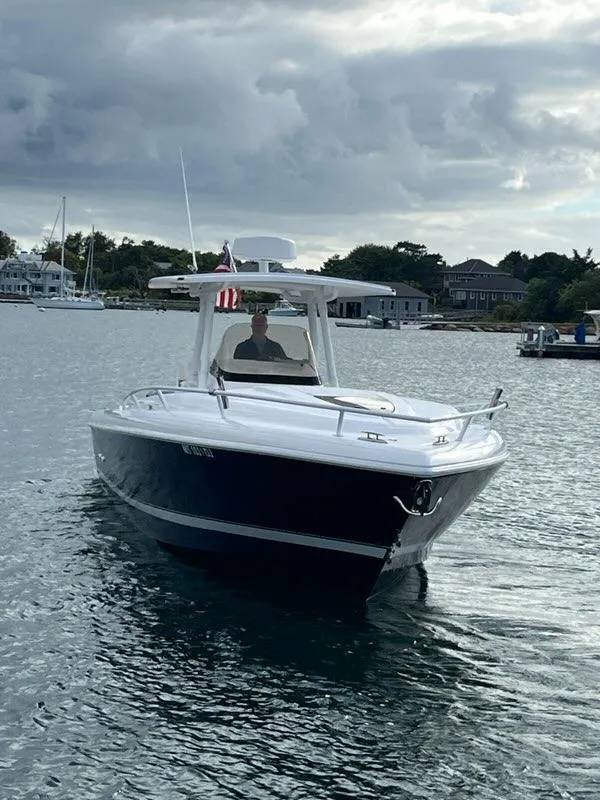 Slide: The Image of 2016 Intrepid 327 Cuddy boat cruising on a calm waterway. - 3